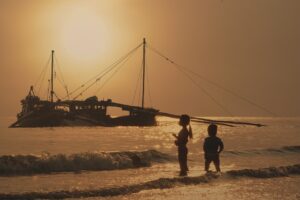 Children watching a boat.