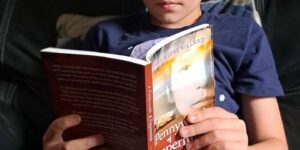 Boy reading Christian children's book